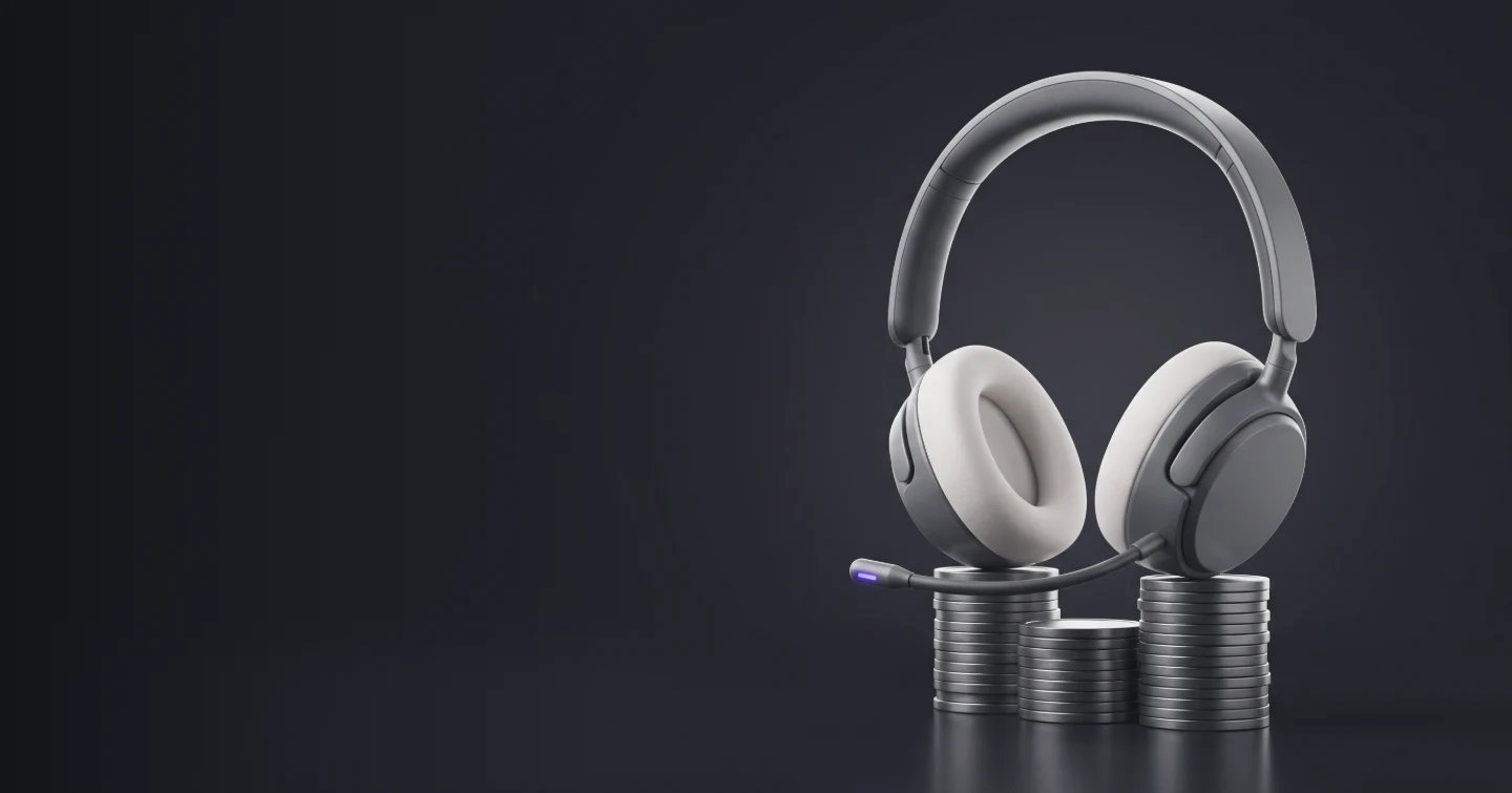 A headset resting on three stacks of coins