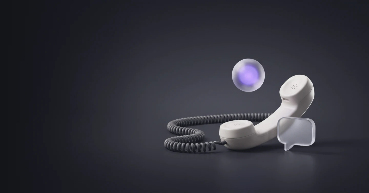 A telephone handset lying on its side beside a chat bubble, with a glowing orb above it picking up the call